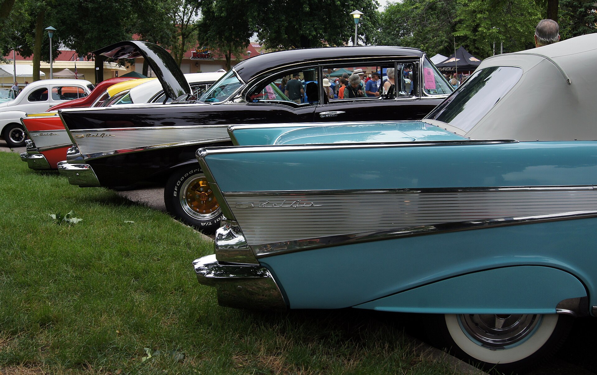 A turquoise 1957 Bel Air rear quarter with the fin and fluted insert visible.