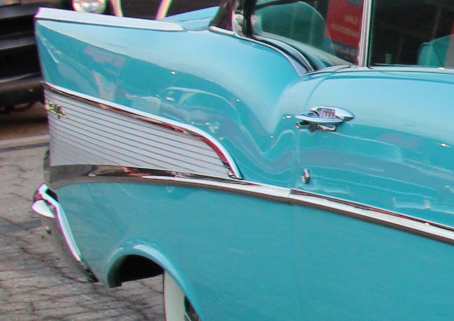 Detail crop of the cover photograph showing the shallow-fluted rear-quarter insert and adjacent door.